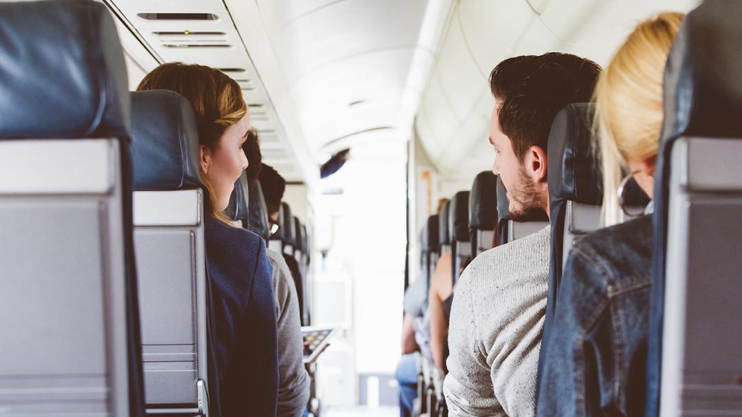 back view of two passengers on airplane